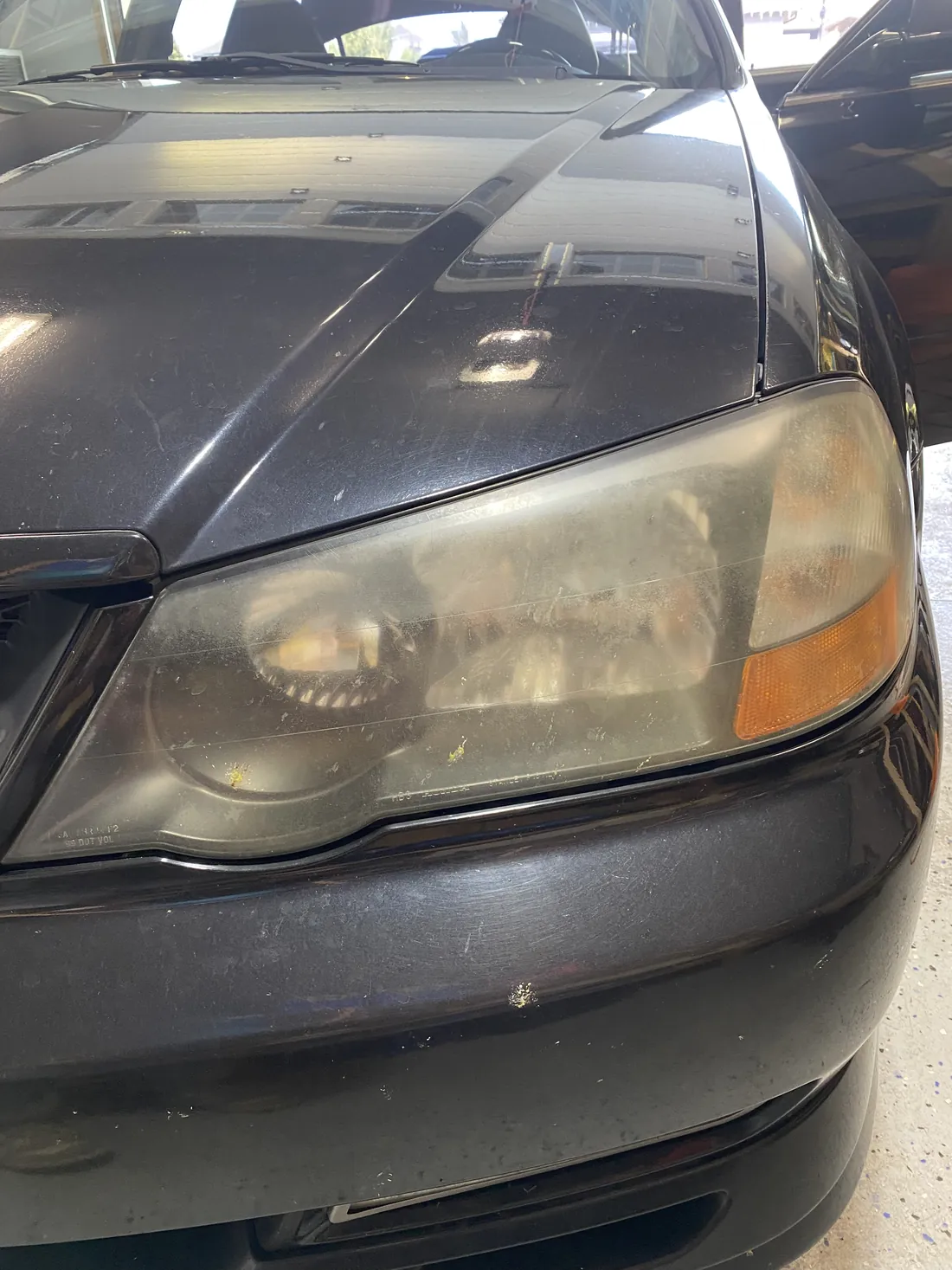 Hazy oxidized headlight before restoration